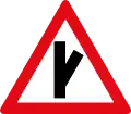 Skewed side road junction ahead to right