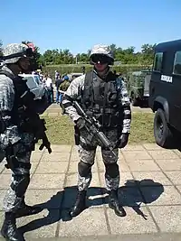 Serbian SAJ police, the one in the center holding a Colt Model 933 while the one on the left holds a SIG SG 552.