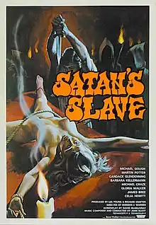 A poster for the film "Satan's Slave". It shows a man armed with a dagger about to stab a naked woman who is tied to a stone altar. In the background, a group of hooded figures look on with lit torches in hand.