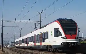 White and red train on a double-tracked railway line