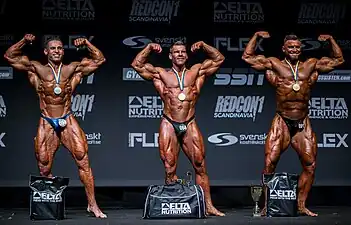 Bodybuilders who have been spray tanned.