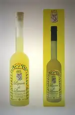 A yellow liquor bottle next to the yellow packaging it is sold in