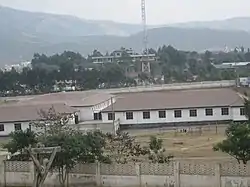 Aerial view of a school campus with hills in the background