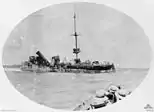A broadside view of the wrecked Emden after her encounter with HMAS Sydney. Crew huddle on the wreck, awaiting rescue by Sydney.