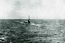 Black and white photo of a surfaced WWI submarine