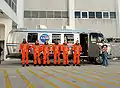 Melvin (center) with STS-129 crew members boarding the astrovan