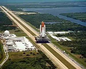Space Shuttle Challenger  atop an MLP atop a crawler, in transit to its launch pad prior to its final flight, January 28, 1986