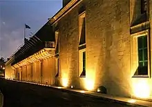 monumental stone building lit by floodlights at night