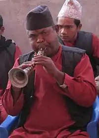 The Nepal version called the sahane, has a curve and is played in the panche baja.