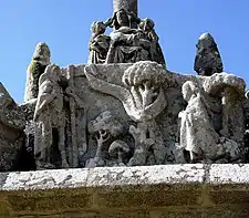 The apparition of the risen Christ appears before Mary Magdalene as recounted in John 20, Verses 11-18. The words "Ne me retiens pas!" "Noli me tangere" are written on a banner across the tree in the middle of the sculpture. These large banners were the forerunners of the modern "thought bubbles" ("bulles de bande dessinees").