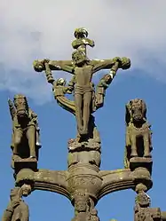 Jesus on the cross with angels holding chalices to collect his blood. Below are two horsed cavaliers