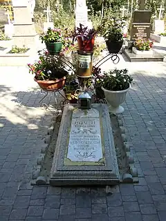 Grave decorated with plants in containers