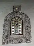 An stucco-carved window grille inside the mosque