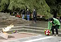 President Salome Zourabichvili laying flowers at the memorial.