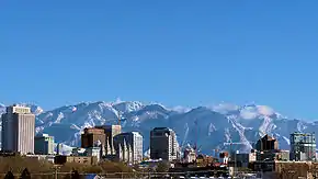 View of a city with snow-capped mountains in the background