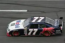 Black-and-white stock car with red Mobil Pegasus on the side