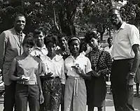 Sanders (far right) and Celtics teammate Sam Jones (far left) pose with youth basketball trophy recipients in the 1960s