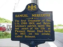 Blue sign reads "SAMUEL MEREDITH: The first Treasurer of the U.S., 1789-1801, and Revolutionary patriot, spent the last years of his life at Pleasant Mount. Died here in 1817, on his estate, called Belmont."