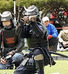 A gunner from the Matsumoto Castle Gun Corps aiming a samurai-zutsu.