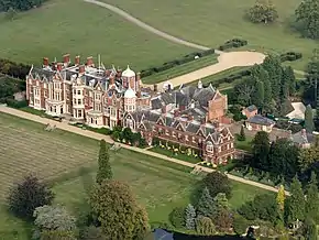 aerial view of large red-brick house in landscape