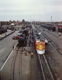 The L.A.-bound Super Chief gets its 5-minute pit-stop service in Albuquerque, 1943