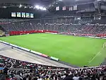 Football field installed inside the stadium, during a football match.