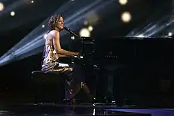 Singer Sarah McLachlan singing and playing the piano