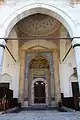 The main entrance portal with an islamic arch before entering, and intricately carved muqarnas on the portal and on the dome pendentives above. There is also  an ablaq design around the main entrance as well.