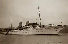 A sepia-toned image of a very large yacht.