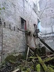 Interior detailing on ruin wall showing where floor joists were hung and former fireplaces