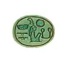 A small steatite scarab with hieroglyphs incised into it
