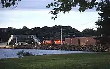 A train station overpass and incoming train