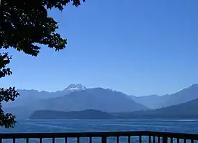 Distant blue mountains separated from viewer by a large body of water
