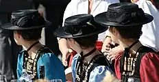 Women in the Bregenz Forest costume with summer straw hats ("Schäohüte")