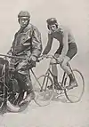 A man on a pacer-motocycle and a male cyclist