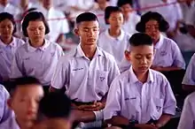 Thai school children meditating as part of organized activities at the school.