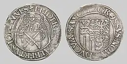Front and back of a silver coin.