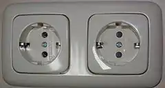 Schuko socket-outlets manufactured by Busch-Jaeger by ABB, RH socket has protective shutters, LH  does not