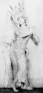 A young white woman in a dance costume and pose evoking Southeast Asian traditions.
