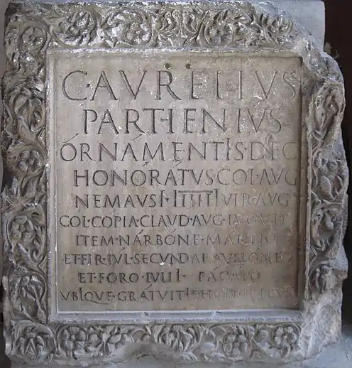 Roman inscription, ca. AD 100, showing long i's contrasting with apices on other vowels, for example órnámentIs in line 3 (besides other words), representing the vowel /iː/.