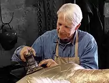 André Harvey works on a sculpture of a seaturtle