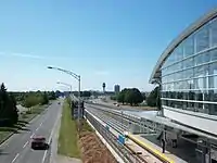 Sea Island Centre station and Grant MacConachie Way, with airport control tower visible in the distance