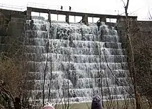 A photo showing a view of the front of Searsville Dam in 2013