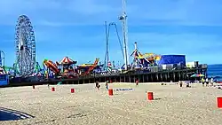 Seaside Heights Casino Pier with amusement rides seen at left and the Atlantic Ocean to the right