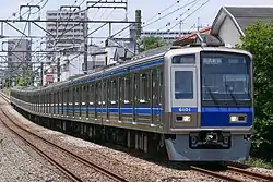 Silver train with blue and white accents on the front-end and body