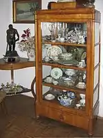 Antique cupboard: Decorative crockery and bibelots in vitré armoire or vitrina