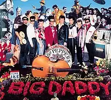 A parody of the Sgt. Pepper's Lonely Hearts Club Band artwork, where the flowers spell out "Big Daddy" and an acoustic bass is in front of the drums.