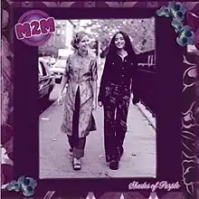 Two teenage girls walking down a street together; the image uses a purple filter. 'M2M' appears in the upper left corner and 'Shades of Purple' appears in the bottom right. The cover has a purple, floral border.