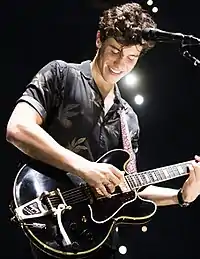 Shawn Mendes performing with a guitar