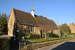 Building with arched window and small turret.